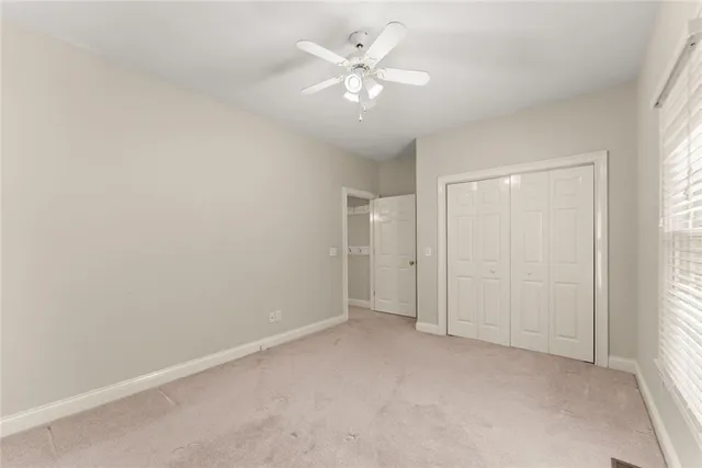 an aerial view of a house with a yard and trees