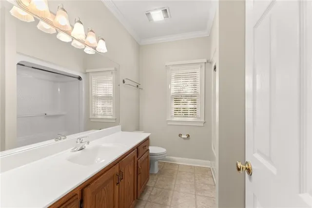 an aerial view of a house with a yard and large trees
