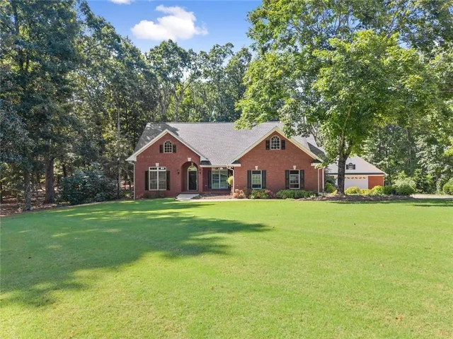 a front view of a house with a yard and porch