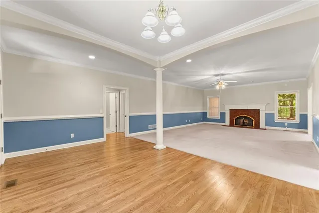 an empty room with a ceiling fan and a window