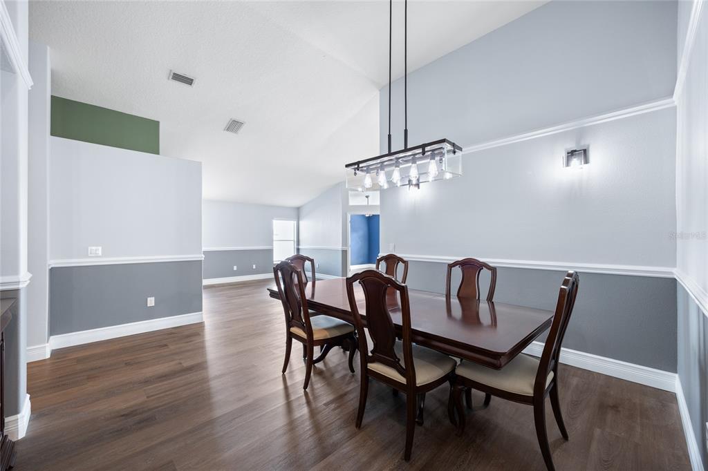 13413 Mandalay Place Spring Hill, FL 34609 - Photo 11 of 46 a view of a dining room with furniture and wooden floor