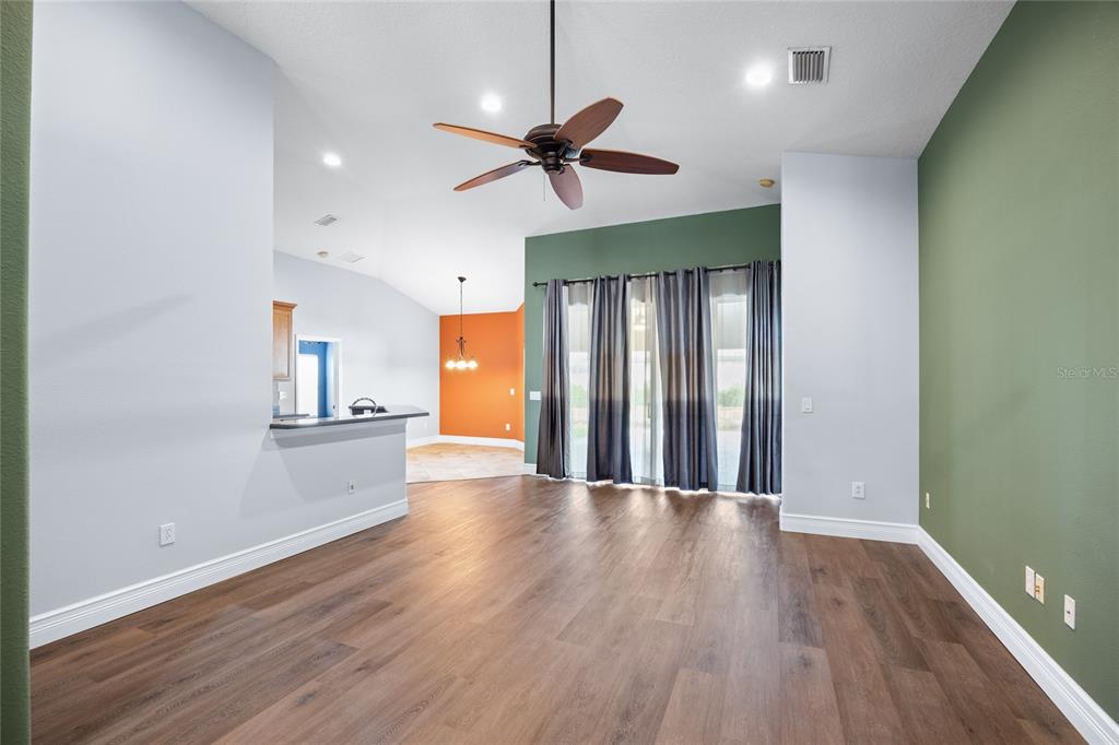 13413 Mandalay Place Spring Hill, FL 34609 - Photo 12 of 46 a view of a livingroom with wooden floor and a ceiling fan
