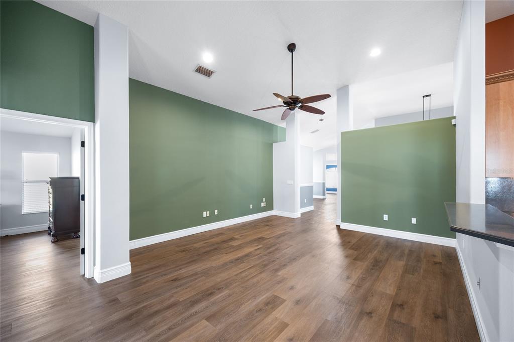 13413 Mandalay Place Spring Hill, FL 34609 - Photo 13 of 46 a view of a hallway with wooden floor and a living room