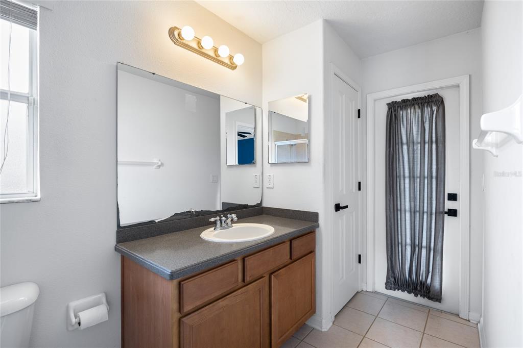13413 Mandalay Place Spring Hill, FL 34609 - Photo 28 of 46 a bathroom with a sink and a mirror