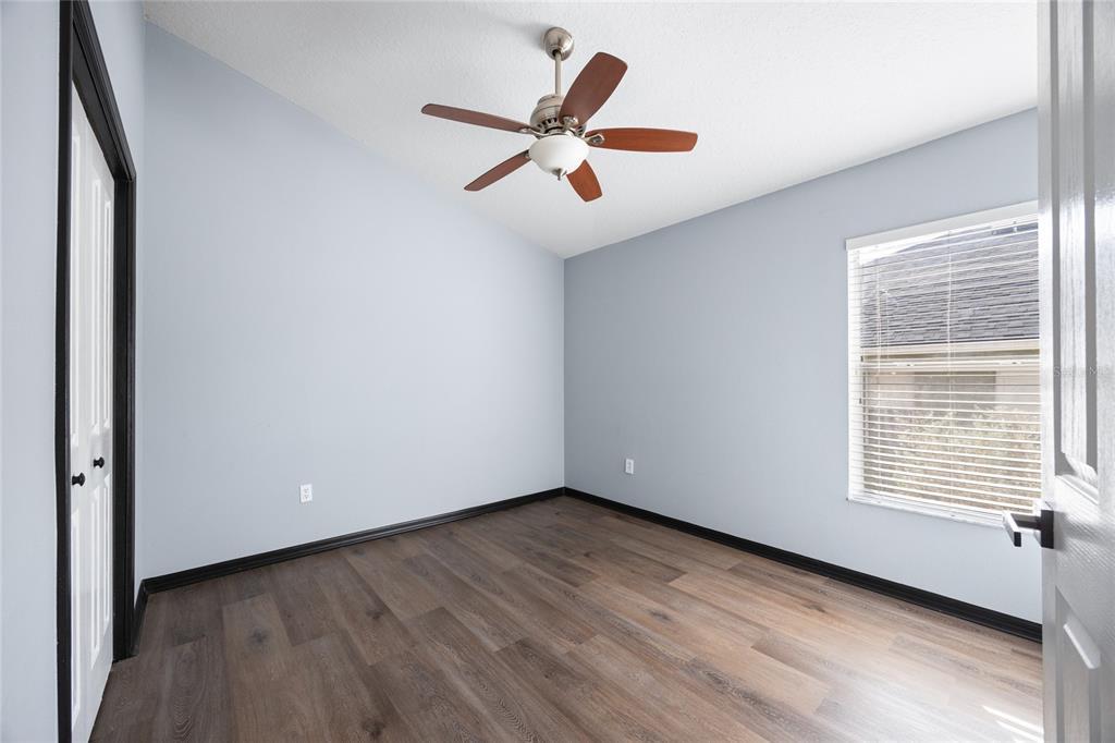 13413 Mandalay Place Spring Hill, FL 34609 - Photo 30 of 46 a view of an empty room with wooden floor and a window