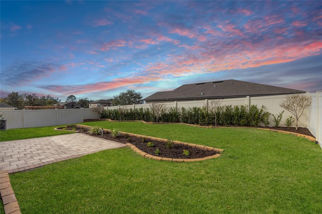13413 Mandalay Place Spring Hill, FL 34609 - Photo 39 of 46 a view of a garden with a lake