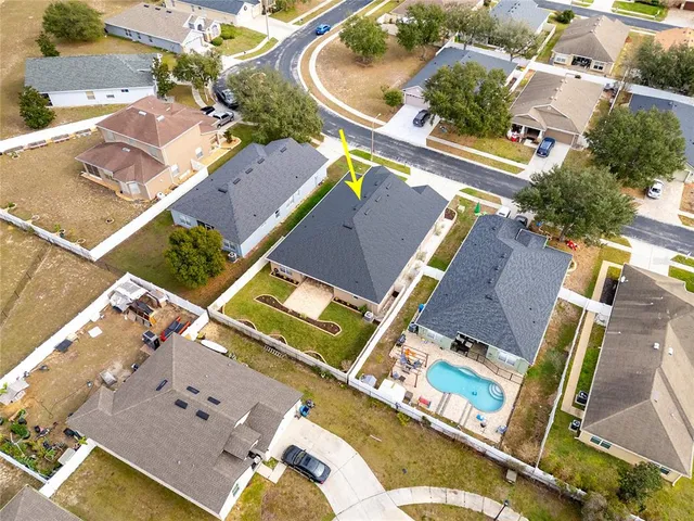 an aerial view of a house with a swimming pool