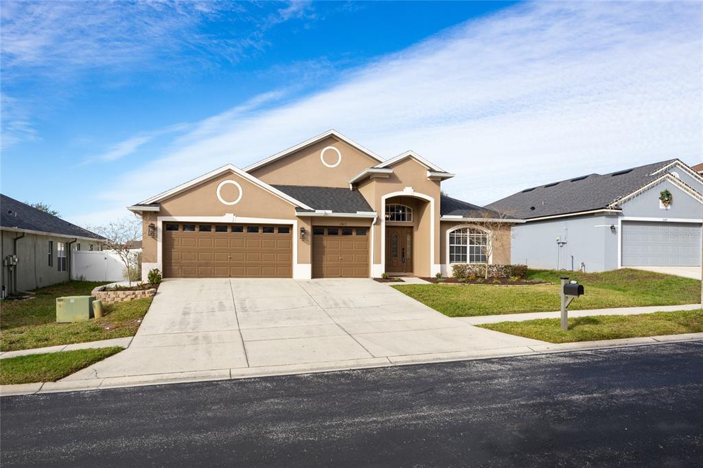 13413 Mandalay Place Spring Hill, FL 34609 - Photo 5 of 46 a front view of a house with a yard