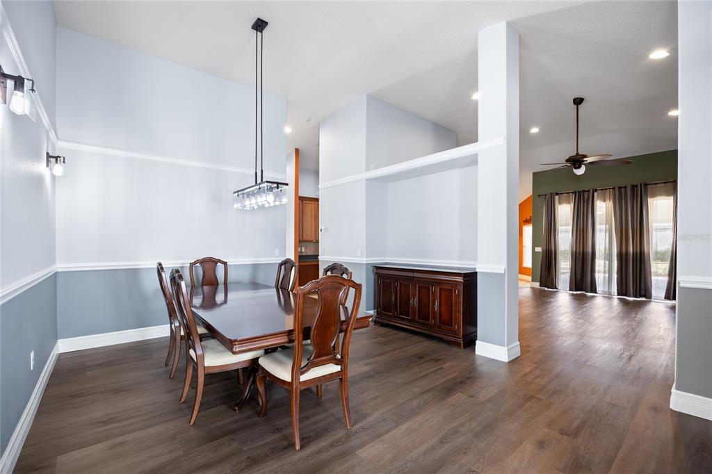 13413 Mandalay Place Spring Hill, FL 34609 - Photo 10 of 46 a view of a dining room with furniture wooden floor and a chandelier
