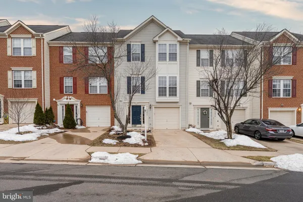 a view of a white building among the street with palm trees