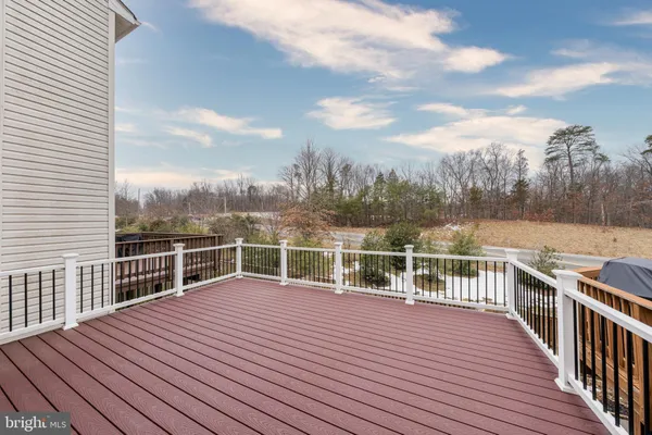 a view of a house with backyard and deck