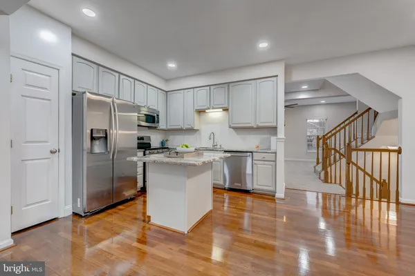 a kitchen with a refrigerator and a sink
