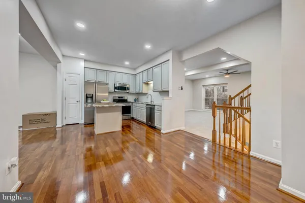 a view of kitchen with refrigerator microwave and stove