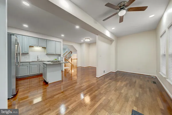 a view of kitchen with sink and refrigerator