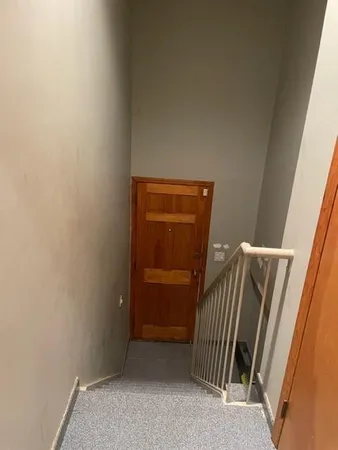 a bathroom with a shower a toilet and a sink