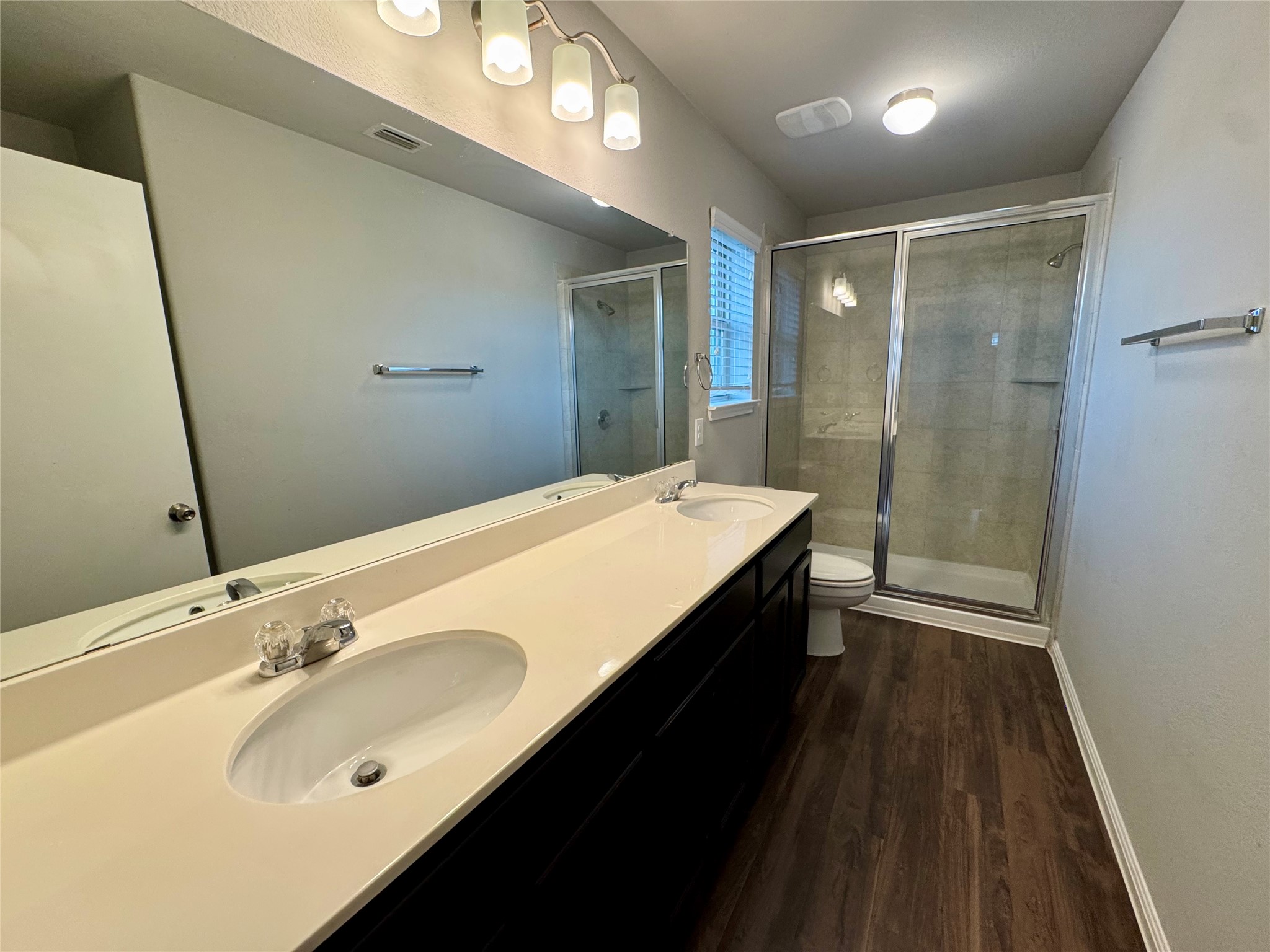 219 Wapiti Road Buda, TX 78610 - Photo 17 of 24 a bathroom with a sink a toilet and shower