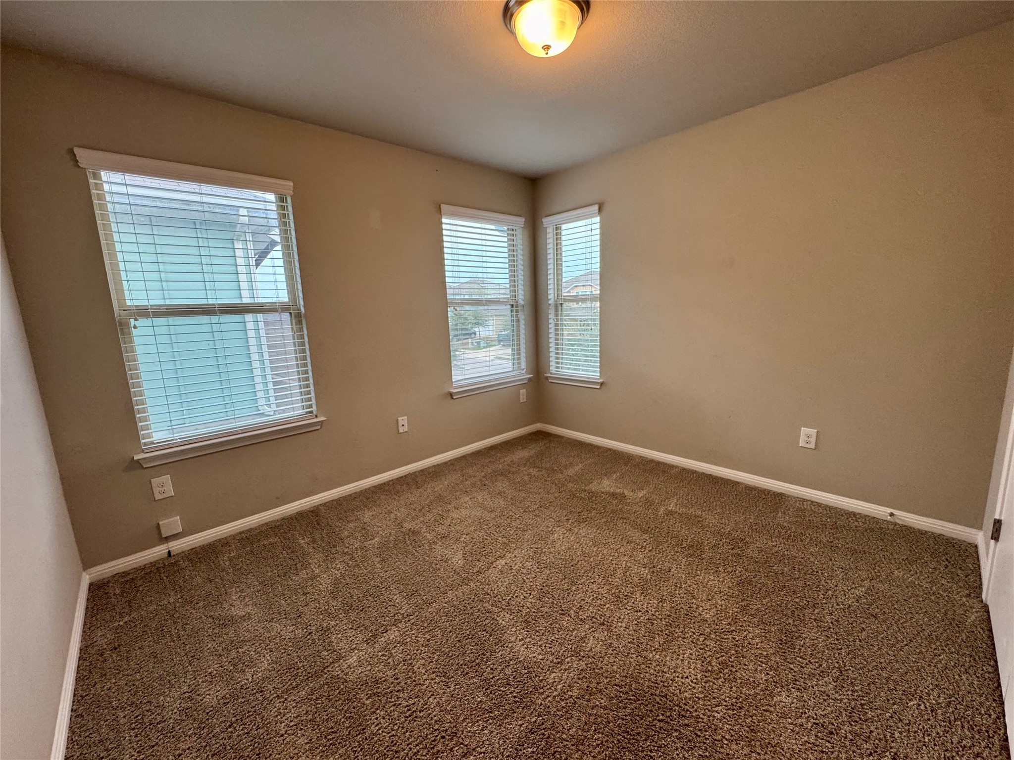 219 Wapiti Road Buda, TX 78610 - Photo 21 of 24 an empty room with windows