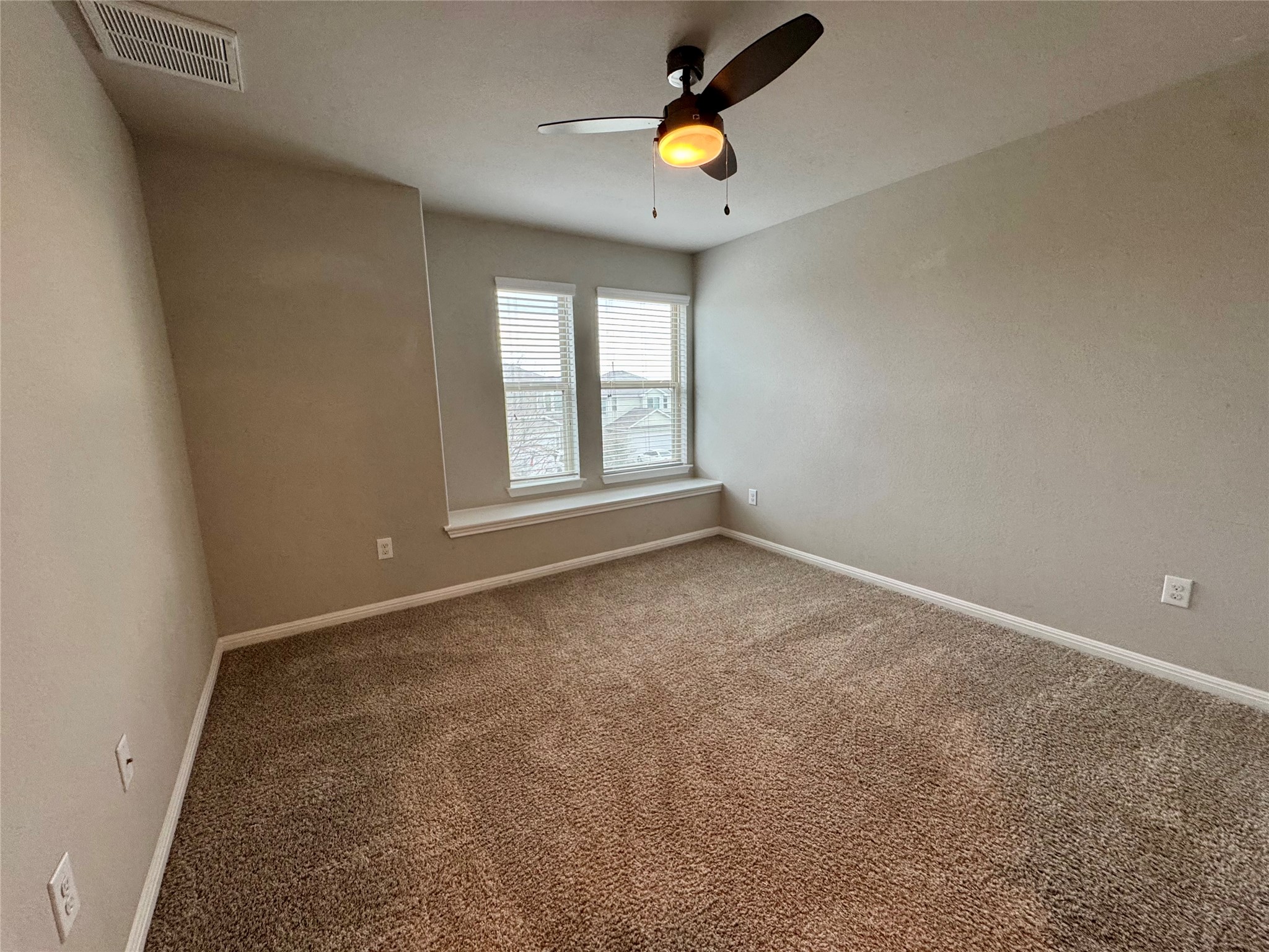 219 Wapiti Road Buda, TX 78610 - Photo 22 of 24 an empty room with windows and wooden door