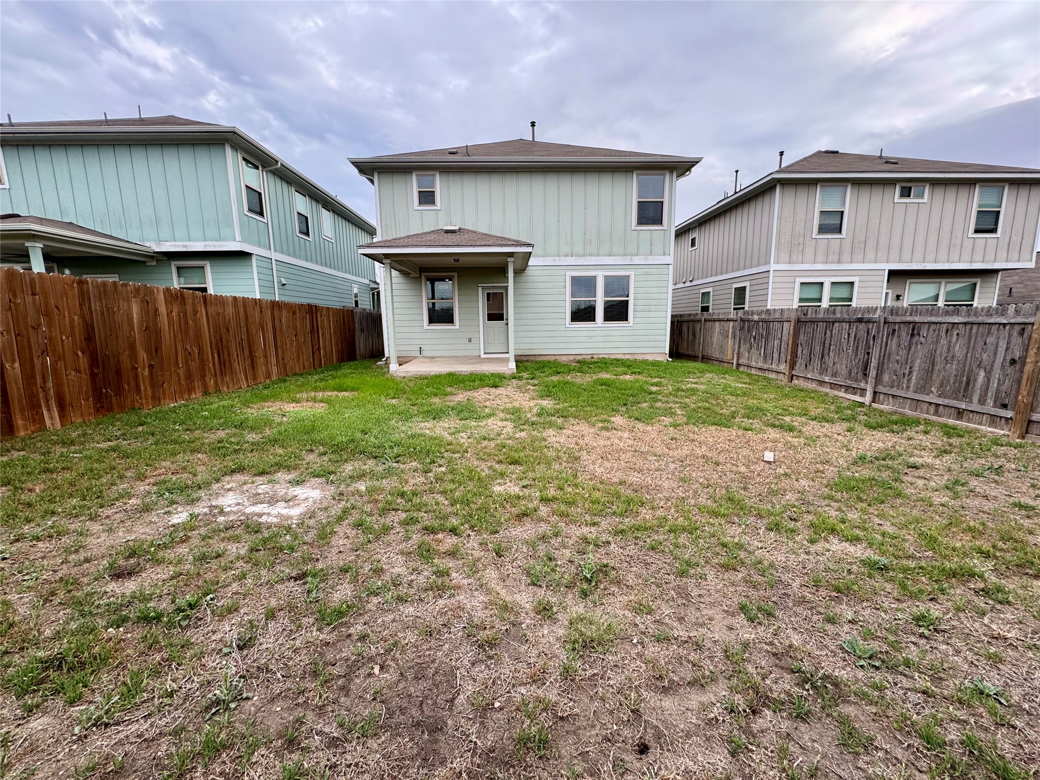 219 Wapiti Road Buda, TX 78610 - Photo 24 of 24 Back of house with a patio and a fenced backyard