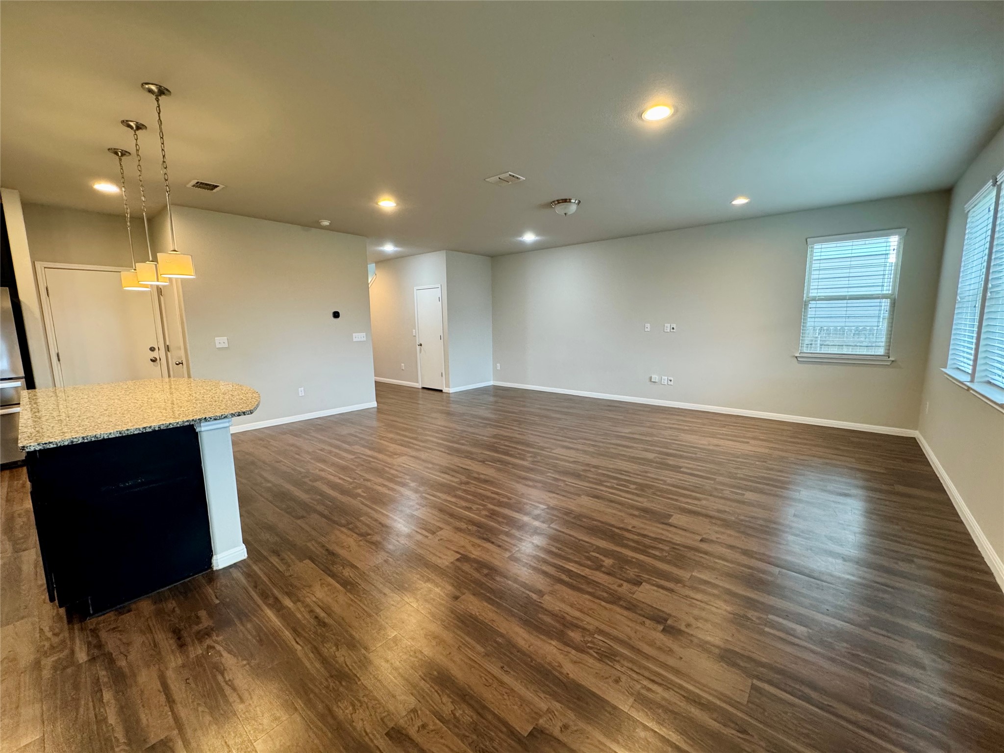 219 Wapiti Road Buda, TX 78610 - Photo 7 of 24 Unfurnished living room featuring dark wood finished floors and recessed lighting