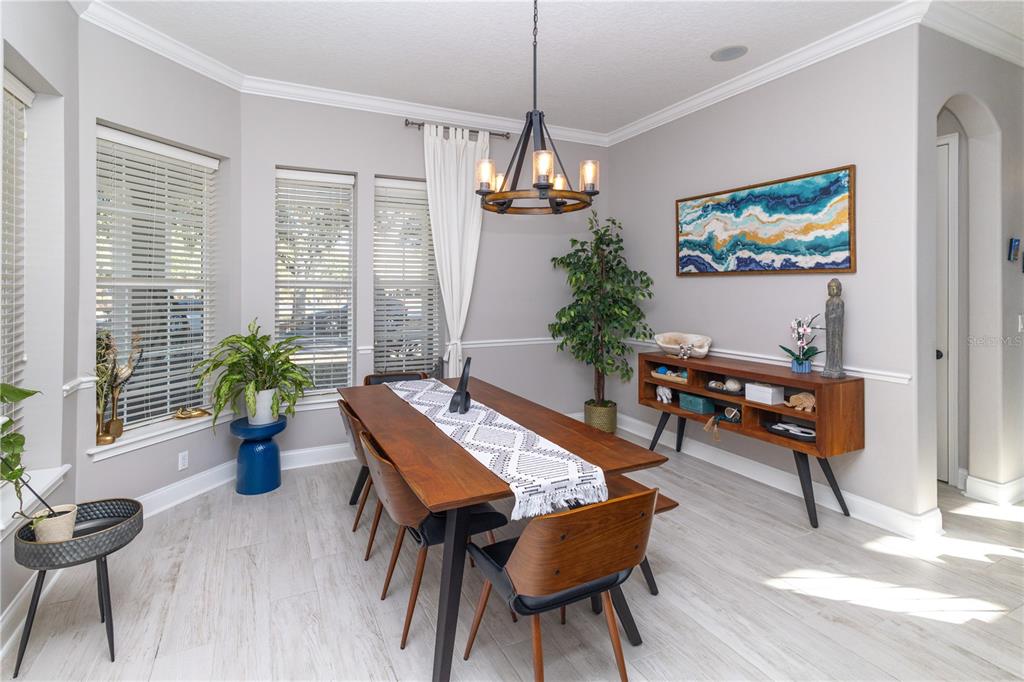 3305 Schoolhouse Road St. Cloud, FL 34773 - Photo 20 of 83 a view of a dining room with furniture window and wooden floor
