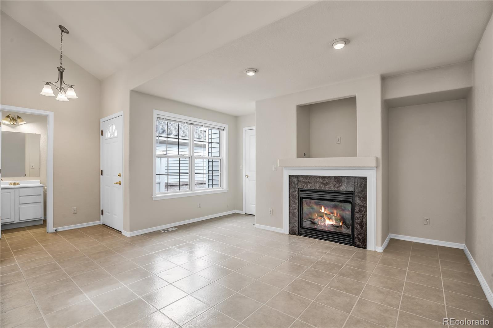 11690 West 46th Avenue Wheat Ridge, CO 80033 - Photo 9 of 33 a view of an empty room with a fireplace and a window
