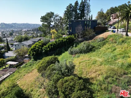 a view of a garden with a building in the background