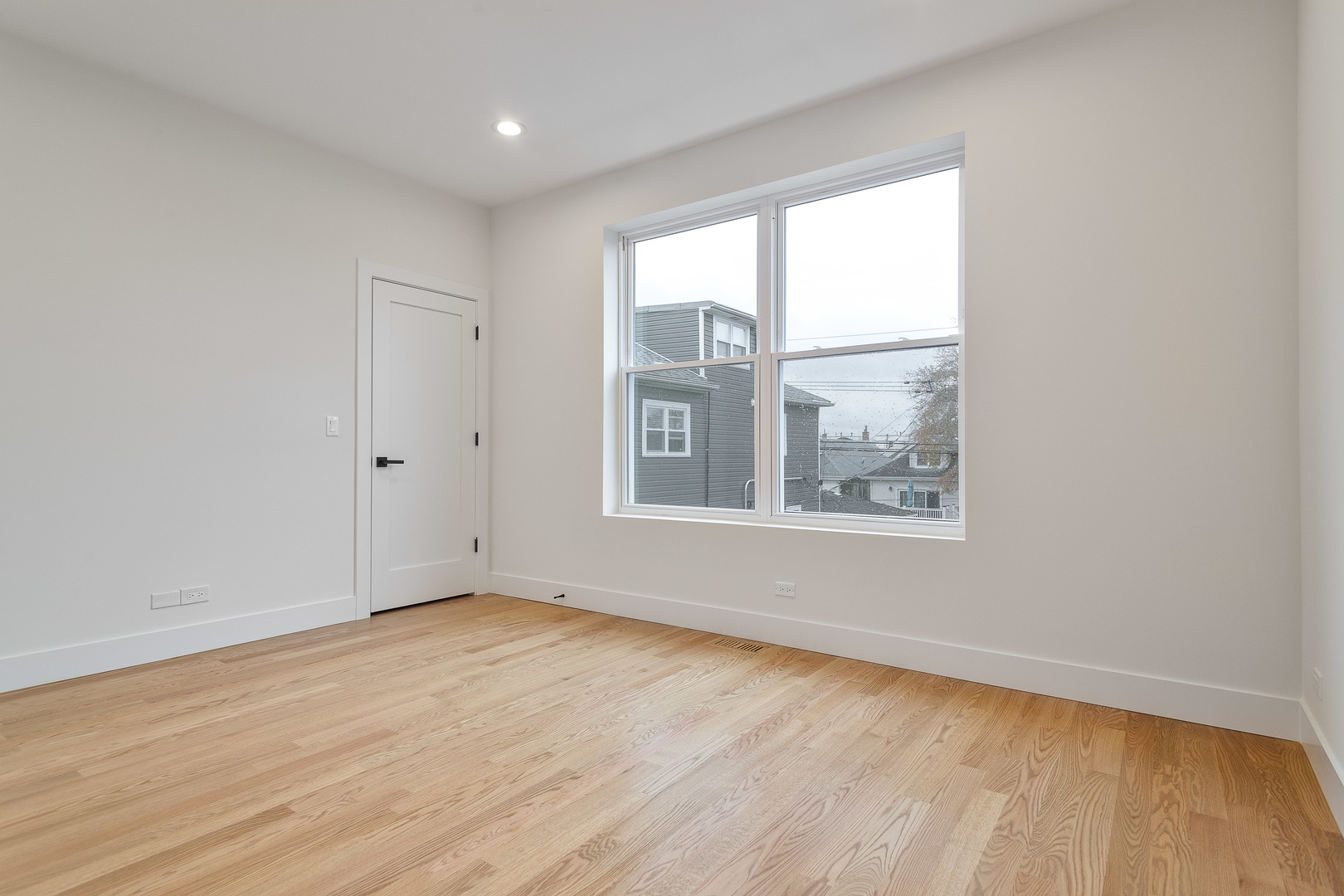 3015 North Normandy Avenue Chicago, IL 60634 - Photo 23 of 28 a view of an empty room with wooden floor and a window