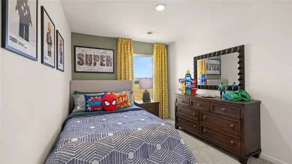 a bedroom with a bed and a dresser in it