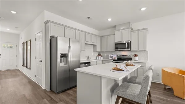 a kitchen with stainless steel appliances a refrigerator stove microwave and cabinets