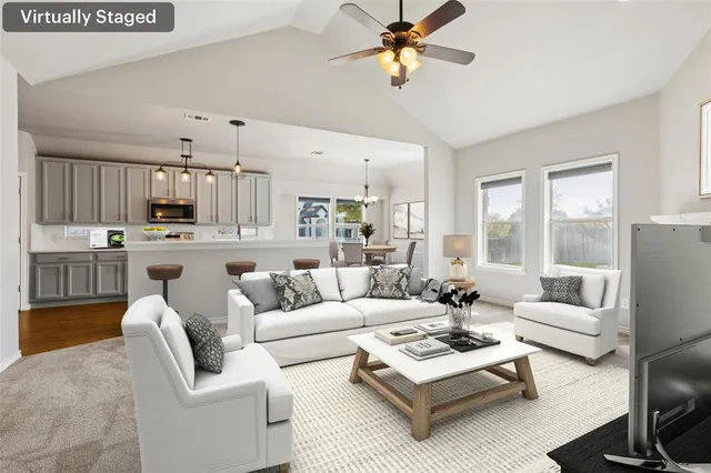 a living room with furniture kitchen view and a chandelier