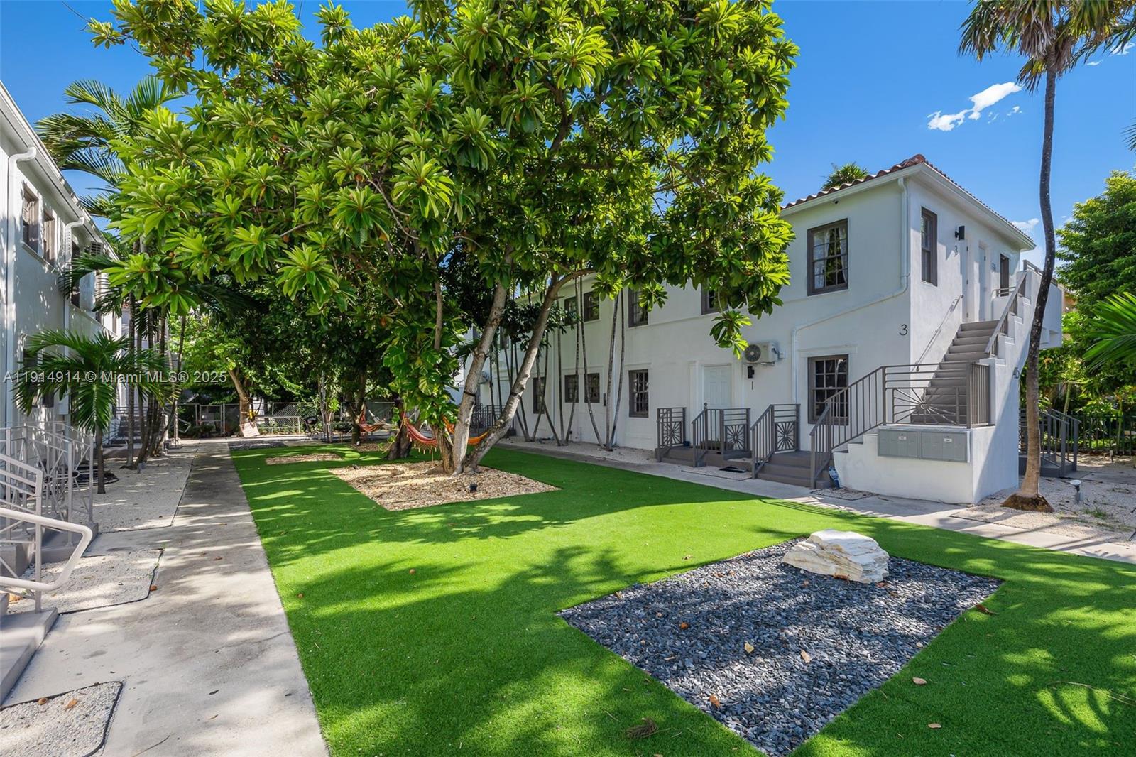 415 75th Street, Unit 1A Miami Beach, FL 33141 - Photo 14 of 19 a view of a backyard with swimming pool