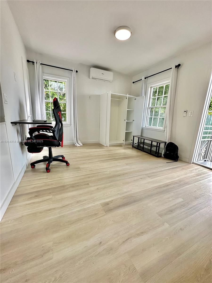 415 75th Street, Unit 1A Miami Beach, FL 33141 - Photo 3 of 19 a view of a room with gym equipment and a window