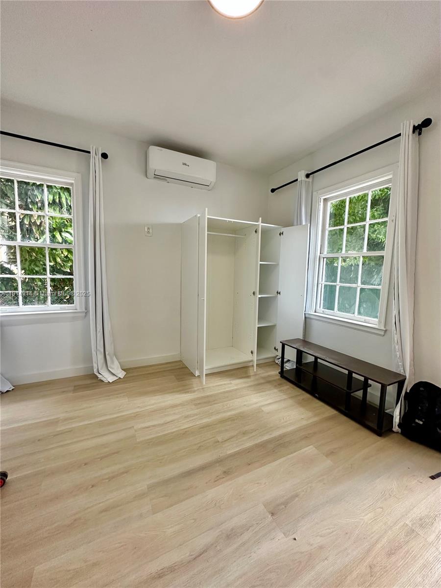 415 75th Street, Unit 1A Miami Beach, FL 33141 - Photo 4 of 19 an empty room with windows