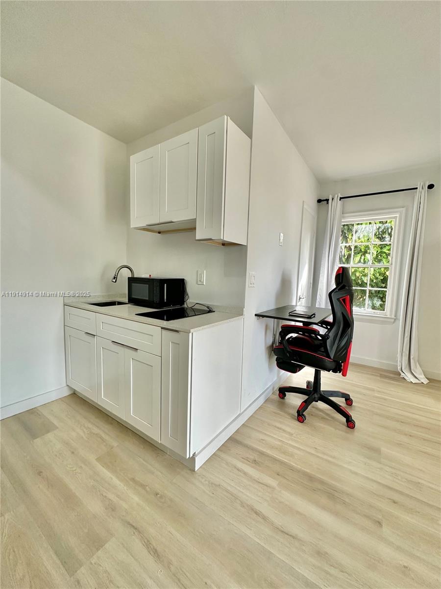 415 75th Street, Unit 1A Miami Beach, FL 33141 - Photo 8 of 19 a living room with furniture and a wooden floor