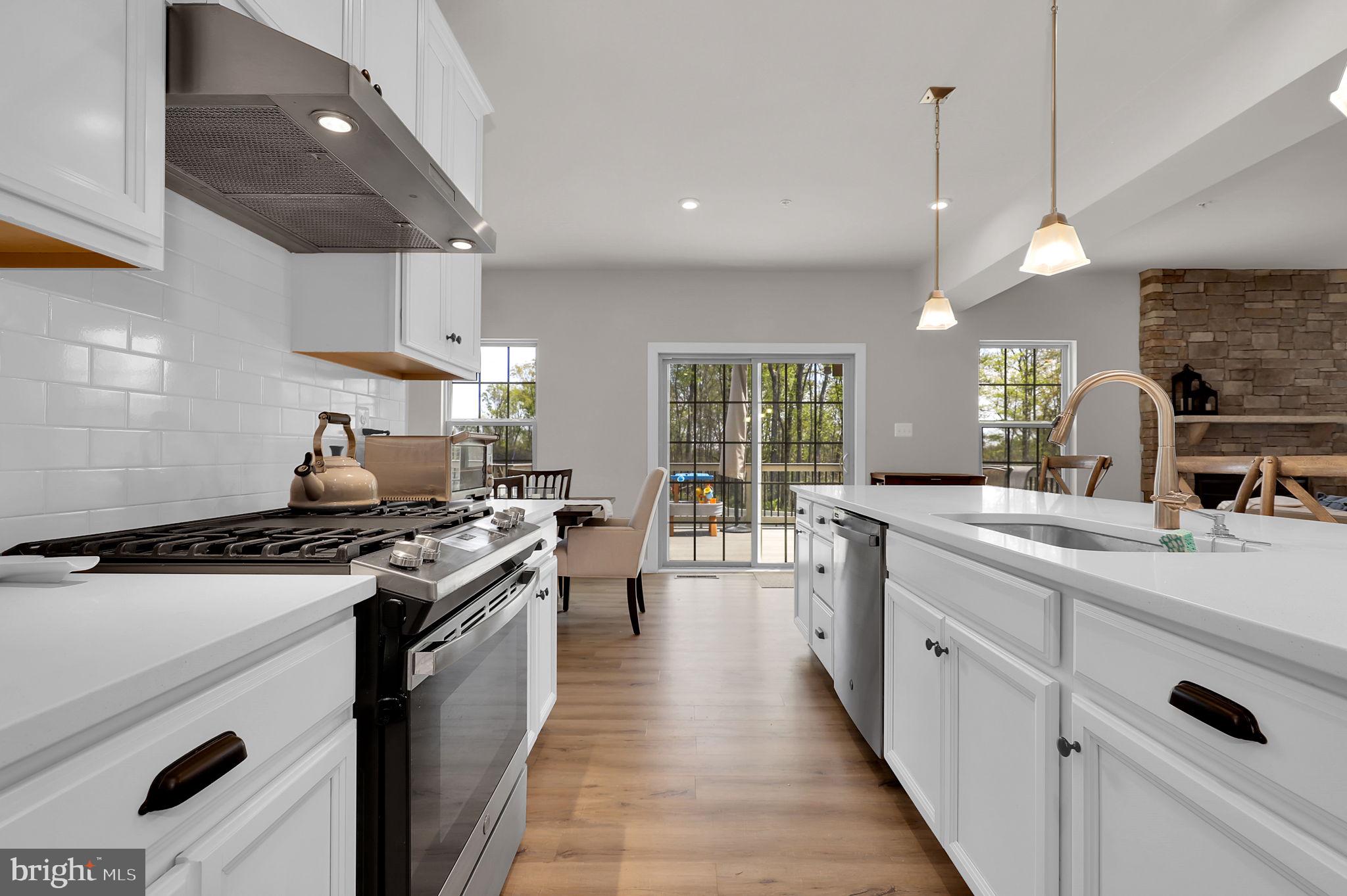 6919 Eaglehead Drive New Market, MD 21774 - Photo 12 of 59 a kitchen with stainless steel appliances a sink stove and cabinets