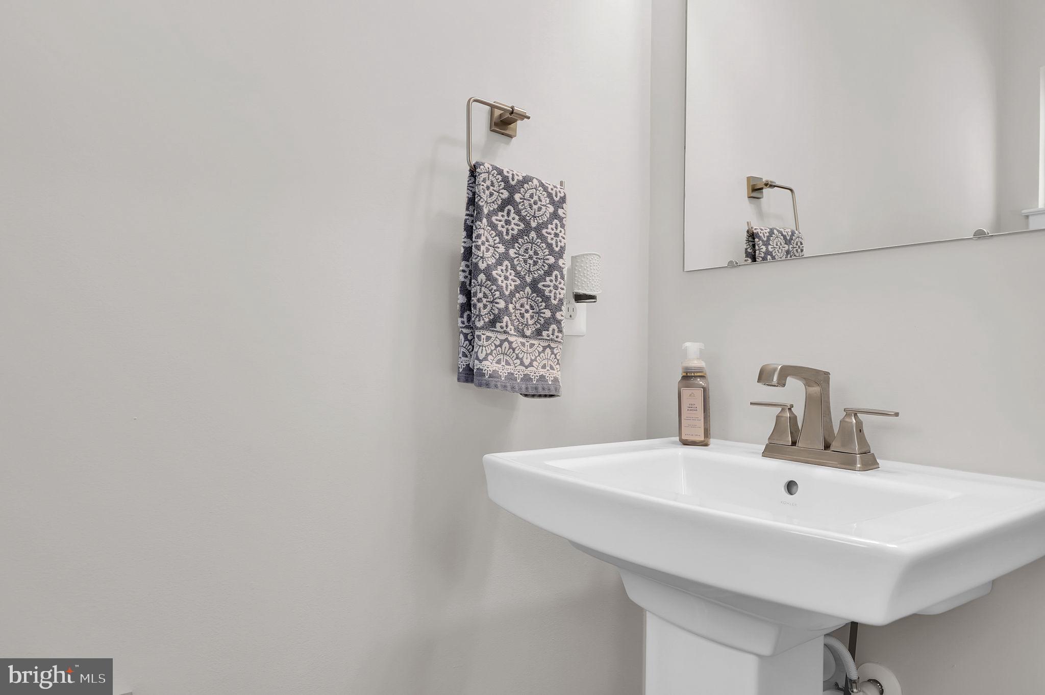 6919 Eaglehead Drive New Market, MD 21774 - Photo 15 of 59 a bathroom with a sink and a mirror