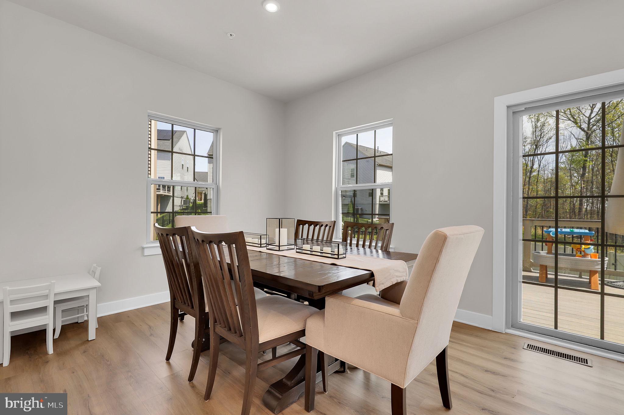 6919 Eaglehead Drive New Market, MD 21774 - Photo 18 of 59 a dining room with furniture and wooden floor