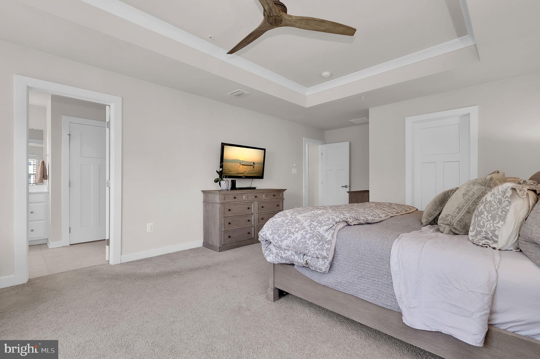 6919 Eaglehead Drive New Market, MD 21774 - Photo 21 of 59 a bedroom with a bed and a flat screen tv