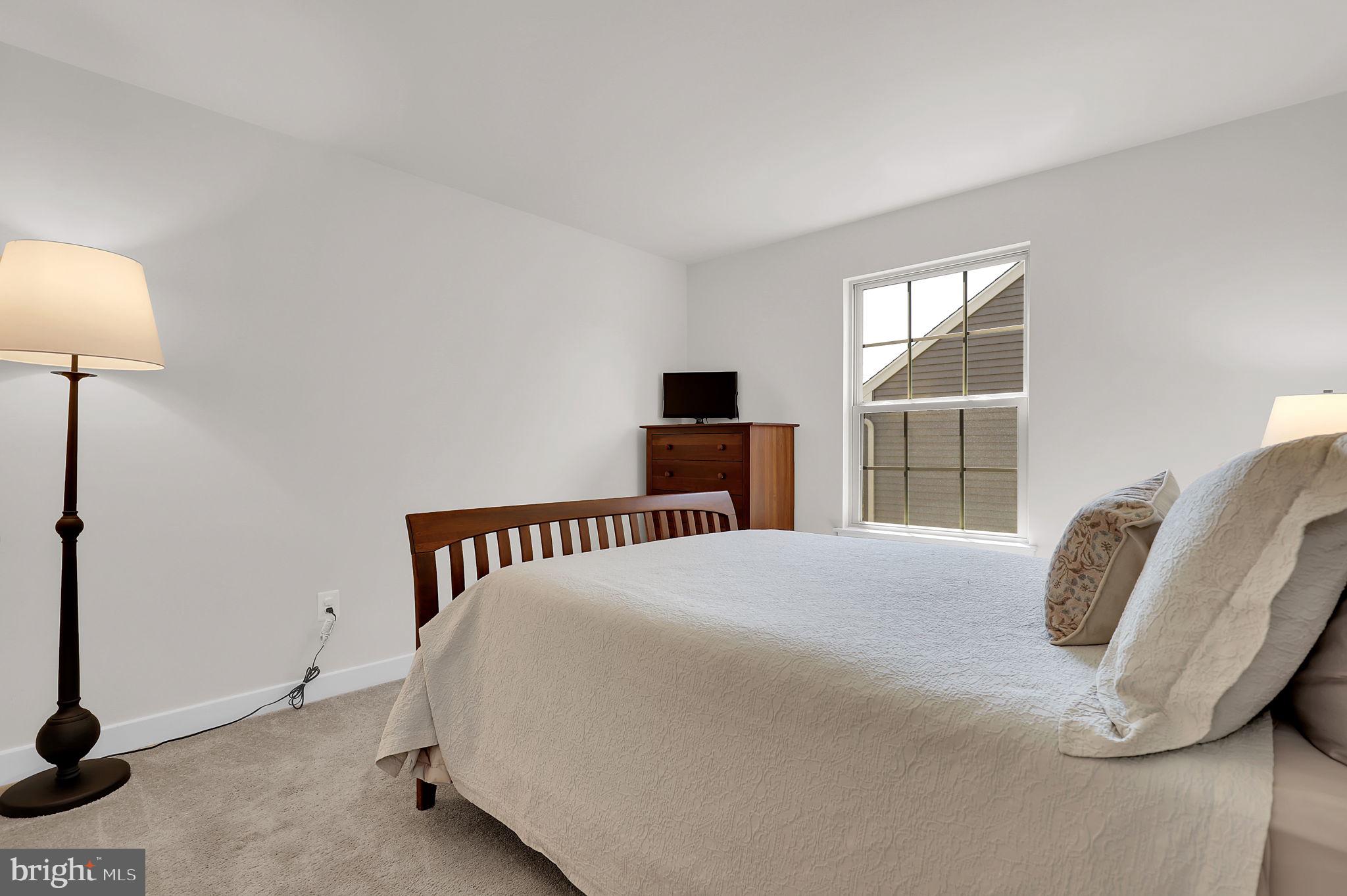 6919 Eaglehead Drive New Market, MD 21774 - Photo 25 of 59 a bedroom with a bed and a lamp