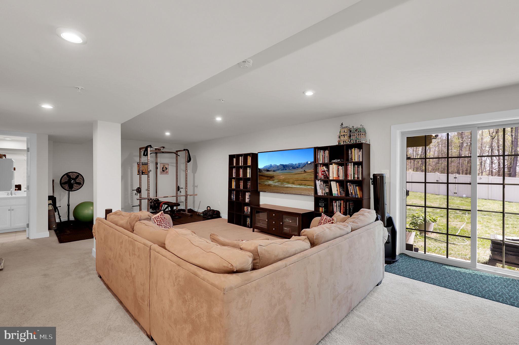 6919 Eaglehead Drive New Market, MD 21774 - Photo 31 of 59 a living room with furniture and a flat screen tv