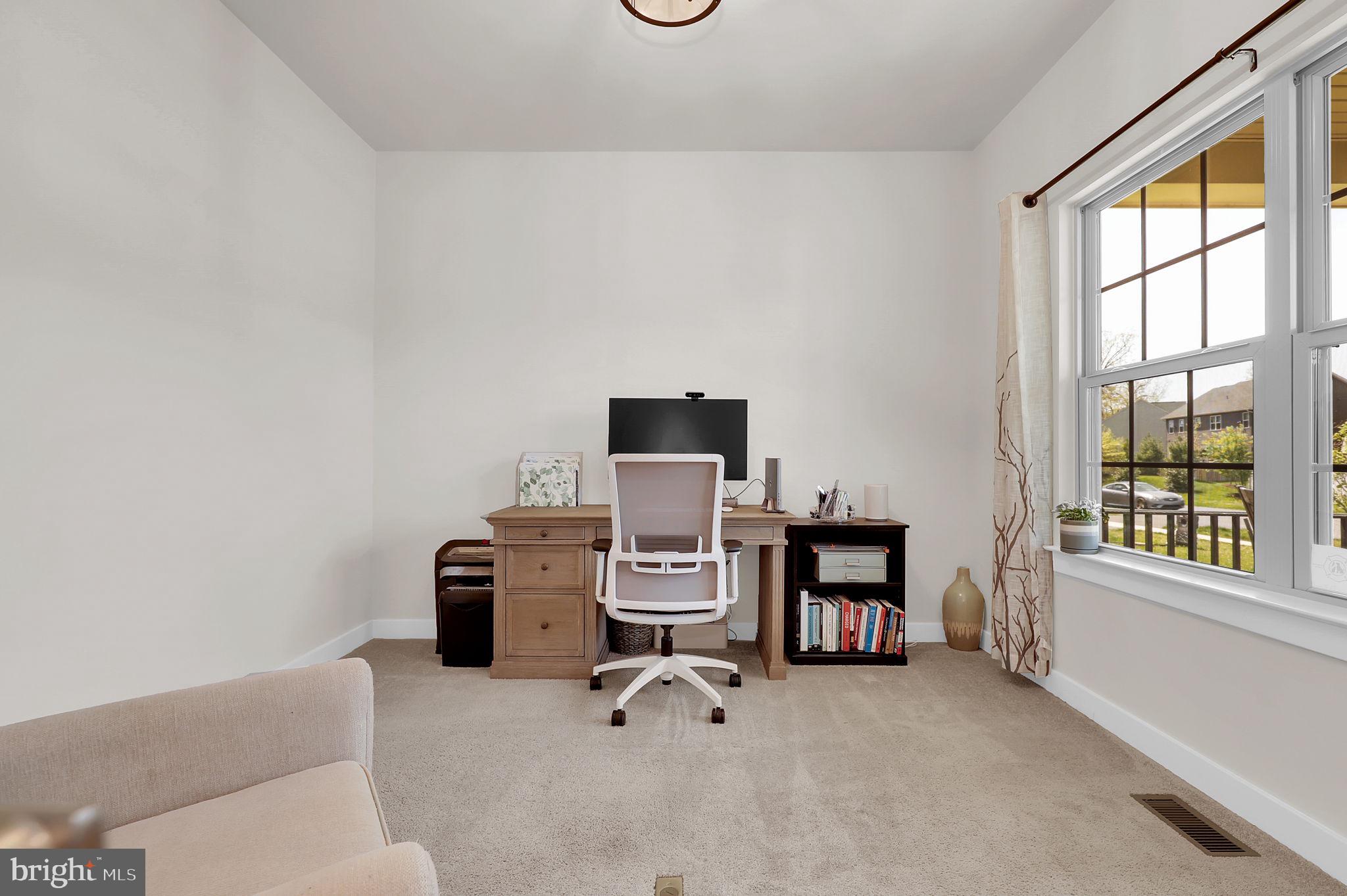 6919 Eaglehead Drive New Market, MD 21774 - Photo 4 of 59 a view of a workspace with furniture and a window