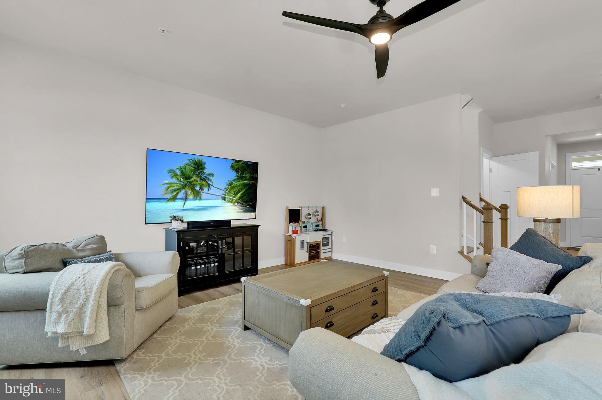 6919 Eaglehead Drive New Market, MD 21774 - Photo 9 of 59 a living room with furniture and a flat screen tv