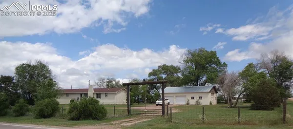 a view of a house with a yard and a garden