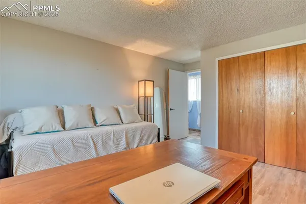 a bedroom with a bed and a chandelier