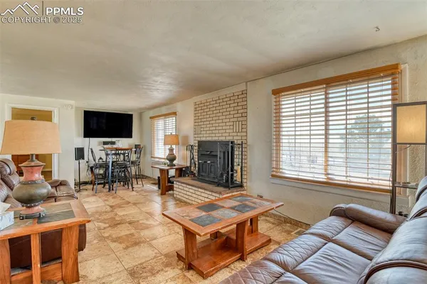 a living room with furniture a couch and large window