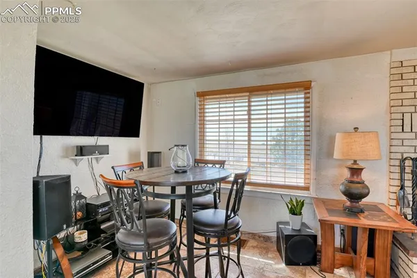 a view of a dining room with furniture and window