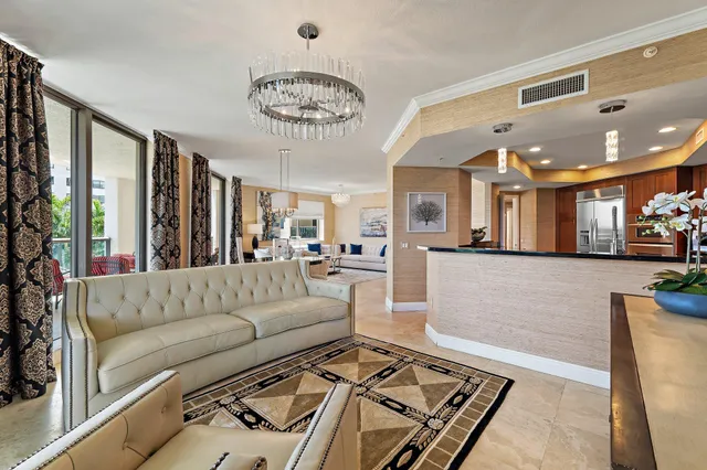 a living room with furniture and a chandelier