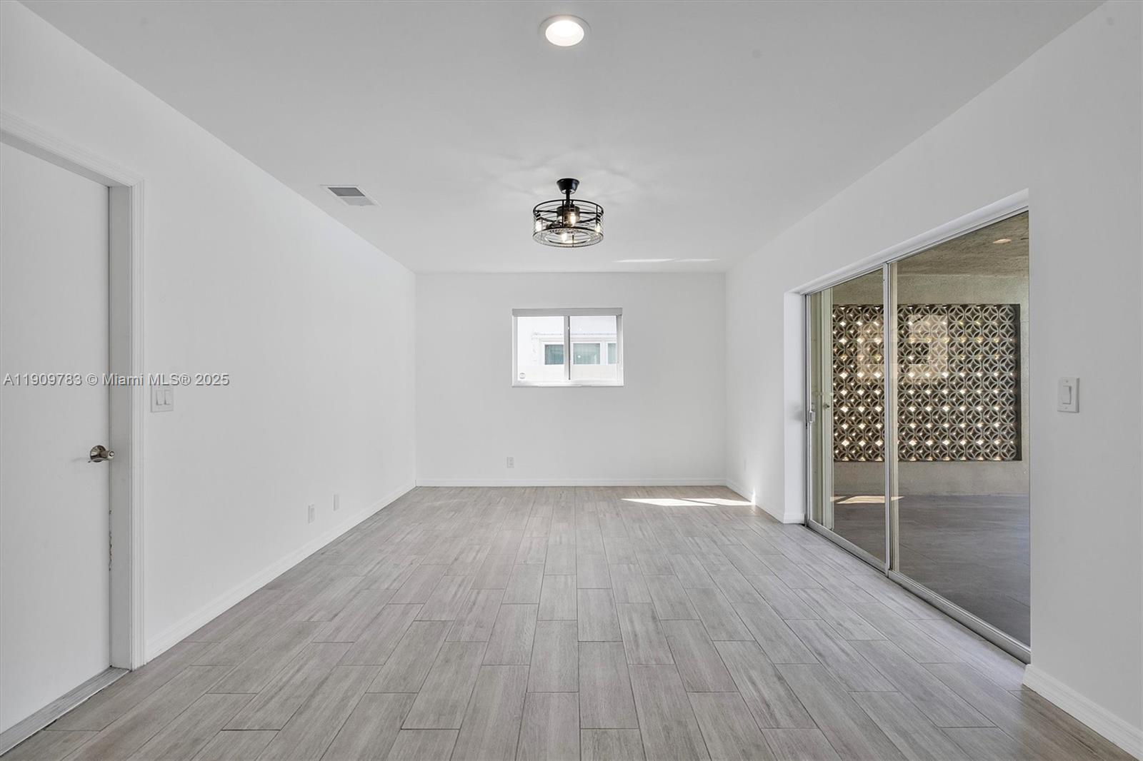 4309 Jackson Street Hollywood, FL 33021 - Photo 16 of 39 wooden floor in an empty room with a window