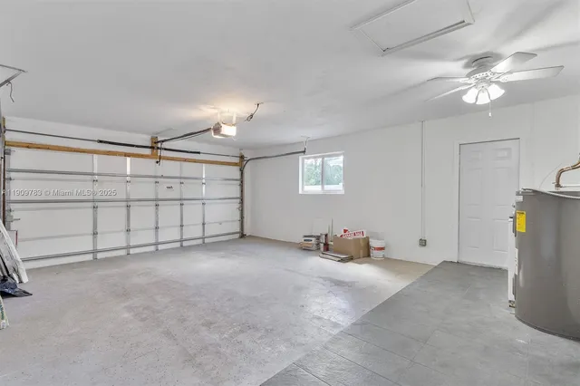 a view of a livingroom with glass windows and chandelier fan